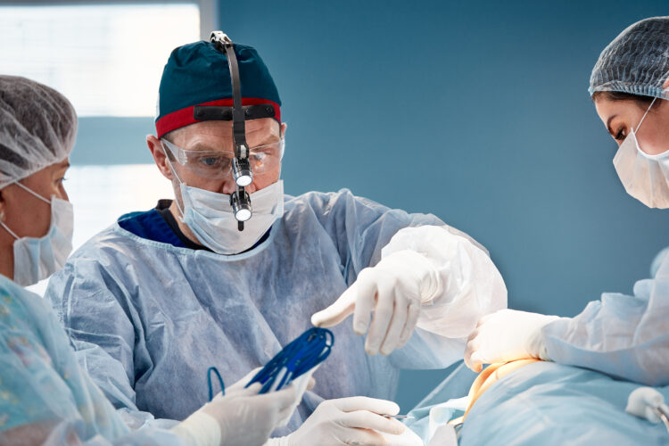 Surgeon assistant feeds coagulator, plastic surgery, professional doctors, close-up